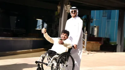 student in wheelchair cherishing success with his university fellow