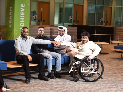 Group of 4 university students posing for a photo
