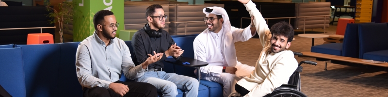 Group of 4 university students posing for a photo