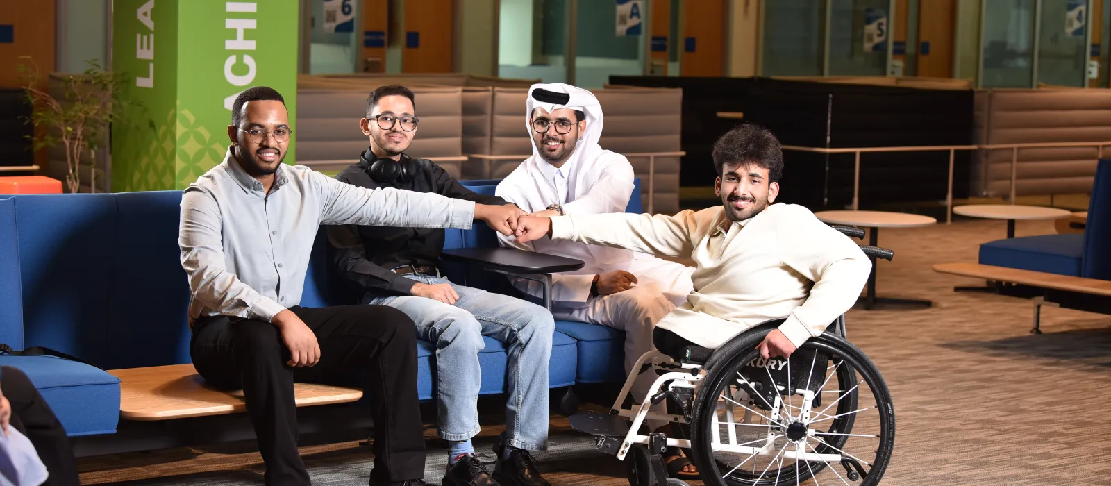 Group of 4 university students posing for a photo
